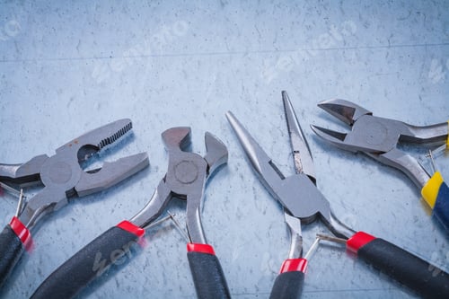 Preview: Composition Of Insulated Metal Nippers On Scratched Metallic Background.