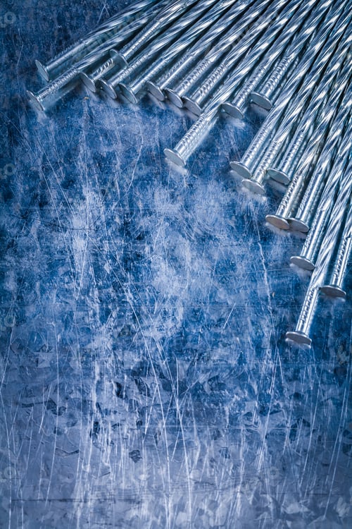 Preview: Composition Of Metal Construction Nails On Scratched Metallic Background Top View Building Concept.
