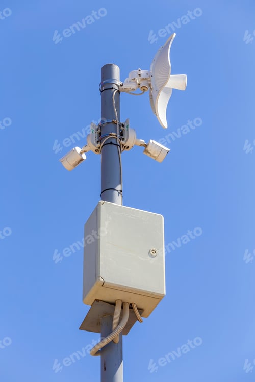 Preview: Wifi Video Surveillance Cameras On A Metal Pole Outdoors With Blue Sky.