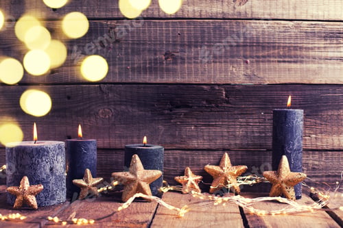 Preview: Golden Stars And Black Burning Candles On Aged Wooden Textured Background. New Year Christmas
