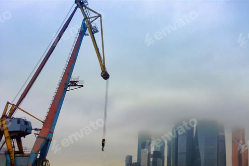 Preview: Construction Of Skyscrapers And High-Rise Buildings Against A Cloudy Sky. The Boom Of A Tower Crane