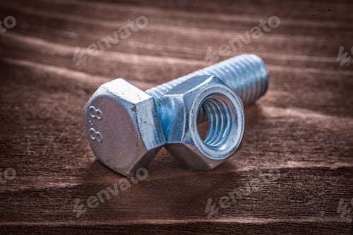 Preview: Threaded Metal Bolt And Screw Nut On Vintage Wooden Board Repairing Concept
