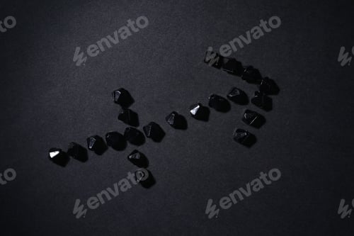 Preview: Symbol Of The Zodiac Sign Sagittarius Made By Black Stones On A Black Background. Low Dark Key