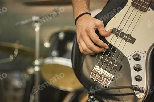 Preview: Detail Of A Bass Player Who Plays His Eacoustica Bass At A Live Rock Music Concert.