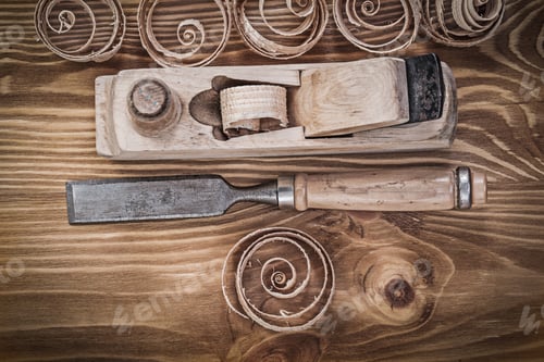 Preview: Planer Chisels Curled Shavings On Vintage Wooden Board Construction Concept.