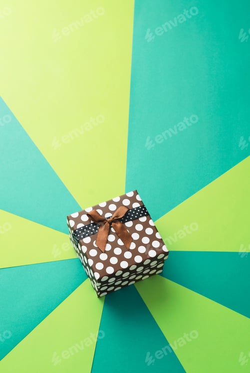 Preview: Christmas Gift Box Over Geometric And Colorful Background, Above View. With Space For Text Or Other