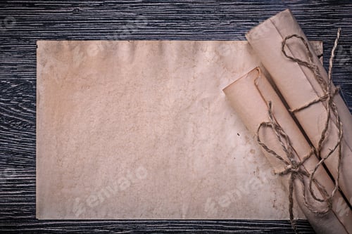 Preview: Vintage Rolled Medieval Paper On Wooden Background.