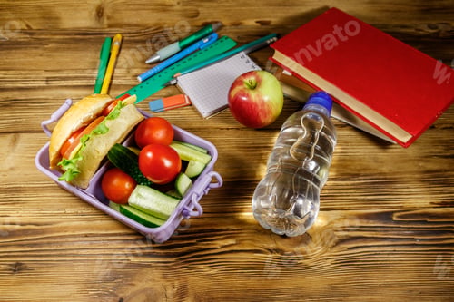 Preview: Back To School Concept. School Supplies, Books, Bottle Of Water, Apple And Lunch Box With Burgers