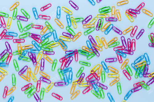Preview: Color Paper Clips On Blue Background, Copy Space. Top View, Flat Lay. Back To School, College