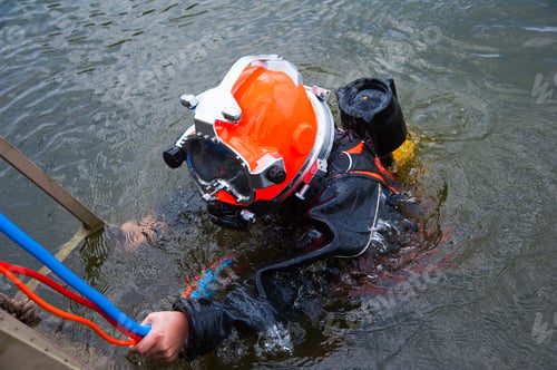 Preview: Diver In The Water In A Diving Suit And Helmet Ready To Dive