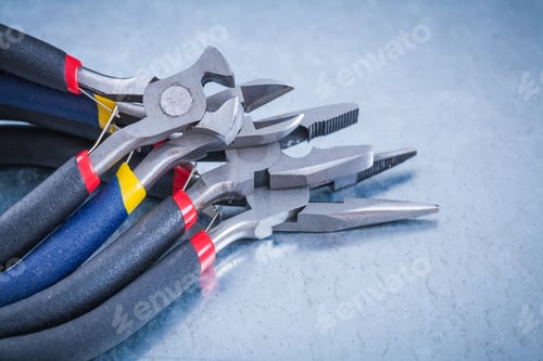 Preview: Collection Of Insulated Nippers On Scratched Metallic Background Construction Concept.