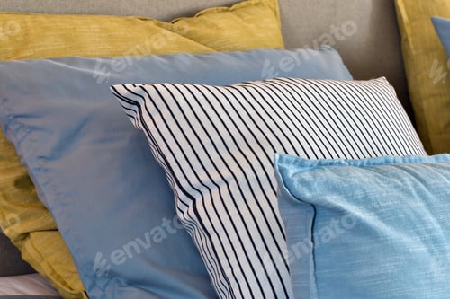 Preview: Closeup Of Yellow And Light Blue Pillows In A Row On The Bed, Modern Retro Decoration For Home