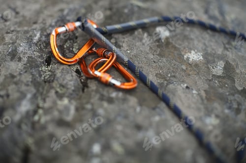 Preview: Climbing Carbines With A Rope On The Background Of A Stone Surface Closeup. Tilt-Shift Effect.