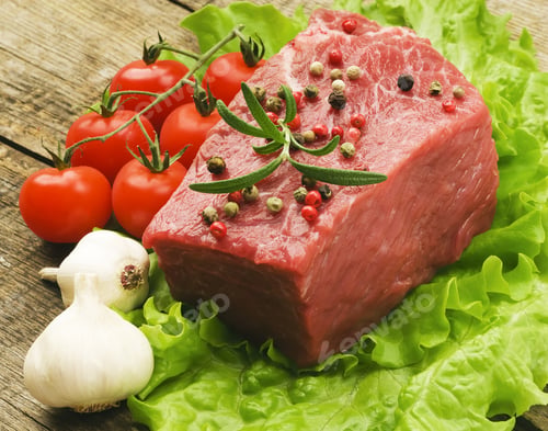 Preview: Raw Steak With Green Lettuce On Wooden Board