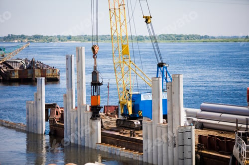 Preview: Piling Machine Working On The River Bank Hammers Piles To Strengthen The Bank And Build A Bridge