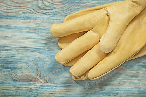 Preview: Leather Yellow Safety Gloves On Wood Board Construction Concept.