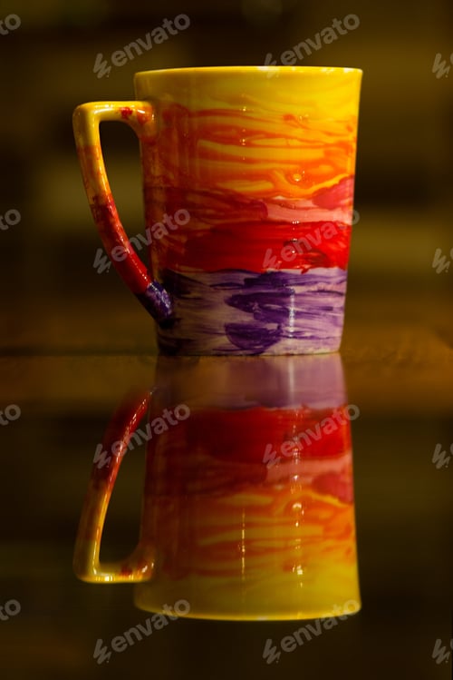 Preview: Colorful Tea Mug, Reflection On The Table.
