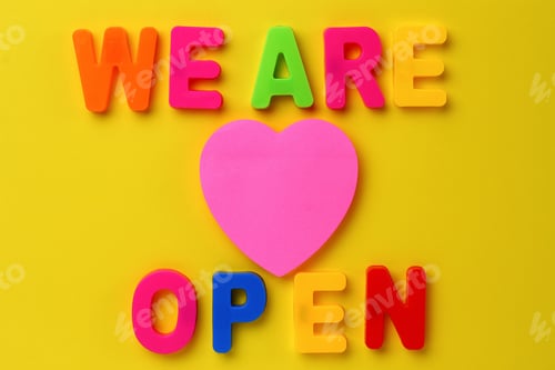 Preview: Text Made In Multicolored Magnetic Letters. We Are Open. Yellow Background