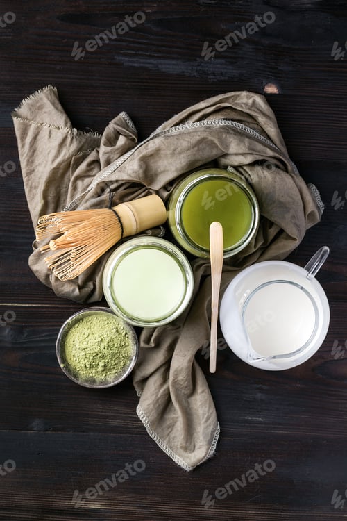 Preview: Green Matcha Tea Served With Cream And Green Matcha Powder With Various Bamboo Accessories For Tea