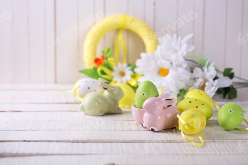 Preview: Easter Background. Colorful Easter Eggs And Rabbit On White Wooden Background. Selective Focus Is