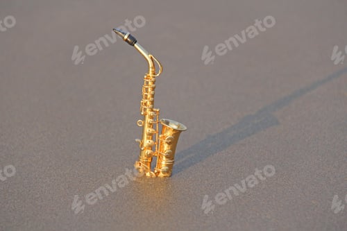 Preview: The Golden Alto Saxophone Stands On The Sand Or On The Beach. Musical Cover And Creative. Design
