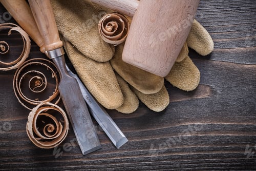 Preview: Pair Of Brown Leather Gloves Firmer Chisels Wooden Mallet And Curled Up Shavings On Vintage Wood