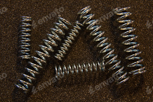 Preview: Flexible Steel Spring On A Dark Background
