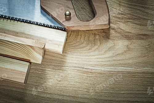 Preview: Hacksaw Wooden Stud On Wood Board Construction Concept.