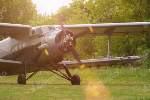 Preview: Classic Old Retro Vintage Airplane With A Propeller At A Green Airfield.