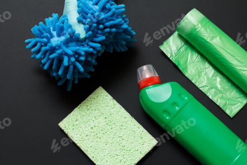 Preview: Hand In A Rubber Glove Holding A Rag Near A Plastic Bottle Of Washing Liquid, A Sponge, Garbage