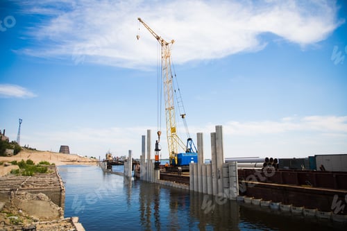 Preview: Piling Machine Working On The River Bank Hammers Piles To Strengthen The Bank And Build A Bridge