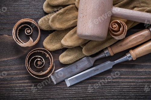 Preview: Pair Of Brown Leather Gloves Firmer Chisels Wooden Hammer And Shavings On Vintage Wood Board