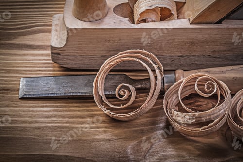 Preview: Shaving Plane Chisels Curled Shavings On Vintage Wooden Board Construction Concept.