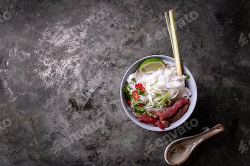 Preview: Traditional Vietnamese Soup Pho Bo Served On The Rustic Metal Background Decorated With Bamboo Chop