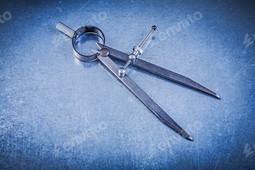 Preview: Metal Construction Pair Of Compasses On Metallic Background.