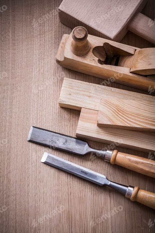 Preview: Hand Mallet Shaving Plane Metal Chisels And Wooden Stud On Brown Board Construction Concept.