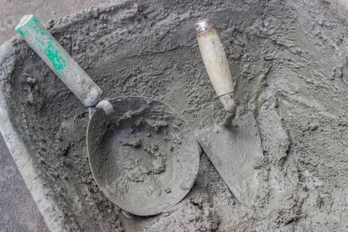 Preview: Mason Mortar Tools In Cement Mixing Trough At Construction Site.