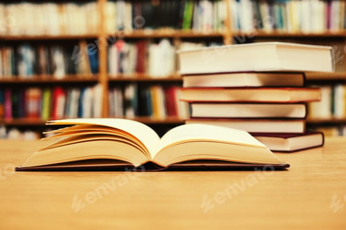 Preview: Stacked Books On A Desk In The Library
