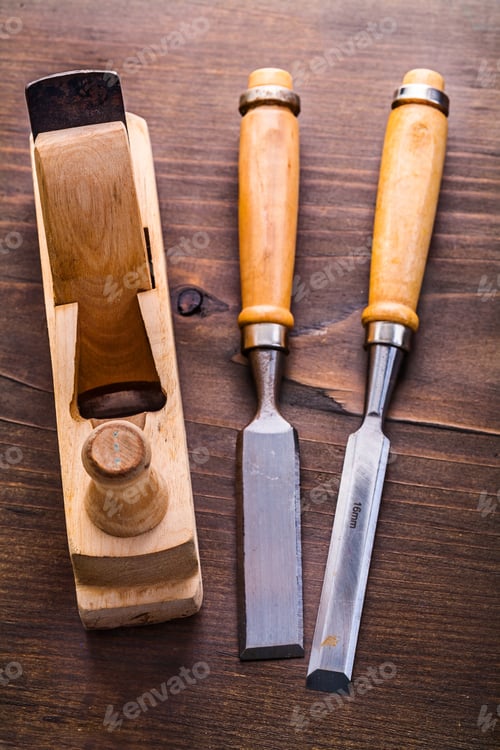 Preview: Chisels And Woodworkers Plane On Vintage Wooden Board