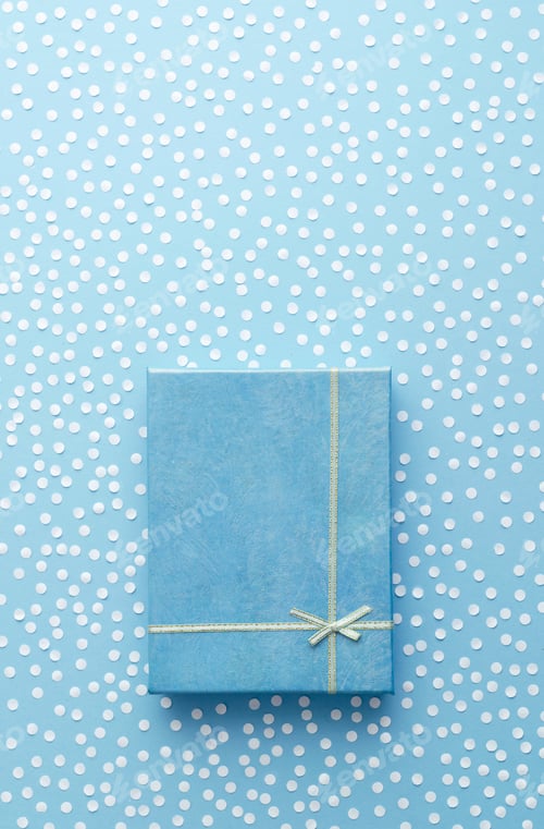 Preview: Christmas Gift Box With Snow Confetti Over Blue Background, Above View. With Space For Text Or