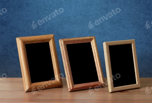 Preview: Wooden Photo Frames On Table, Blue Wall