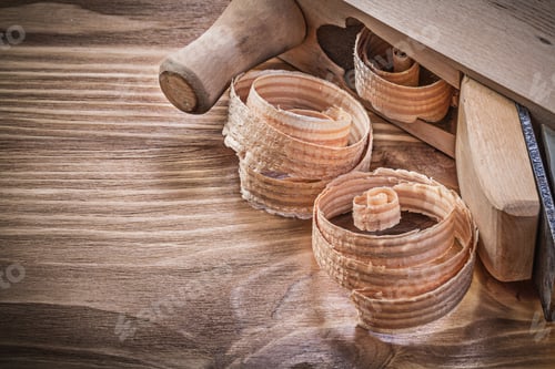 Preview: Shaving Plane Curled Shavings On Vintage Wooden Board Construction Concept.