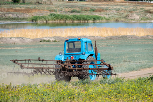 Preview: Old Tractor With Harrow Is Driving Along The Country Road