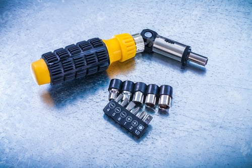 Preview: Reversible Turnscrew Set Of Screw Bits And Torxes On Metallic Background Construction Concept.