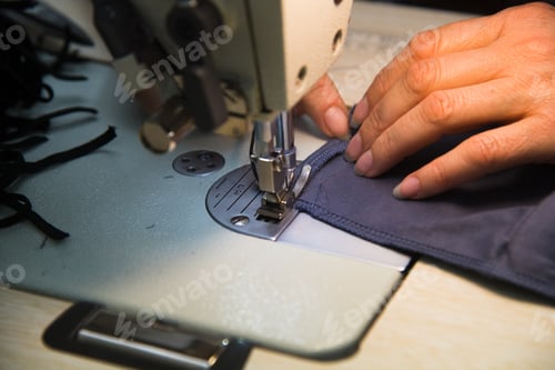 Preview: Woman Hands With Fabric At Sewing Machine. Seamstress Working Behind Her Equipment. Tailoring