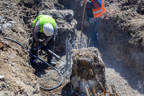 Preview: Jackhammer In Action Break Reinforced Concrete Pillar In The Ground At A Construction Site.