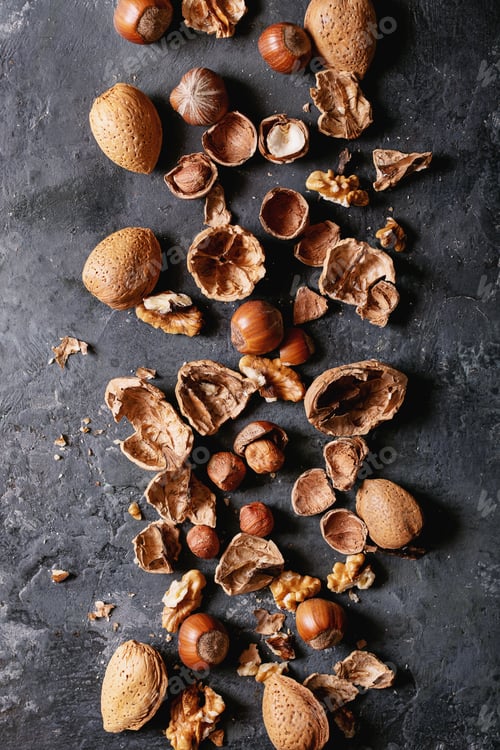 Preview: Varieties Of Nuts: Almonds, Hazelnuts And Walnuts Over Dark Texture Background. Top View, Flat Lay