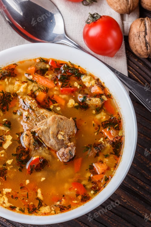 Preview: Georgian Soup. Kharcho With Rice, Tomato, Beef, Garlic And Herbs In Bowl On Wooden Table