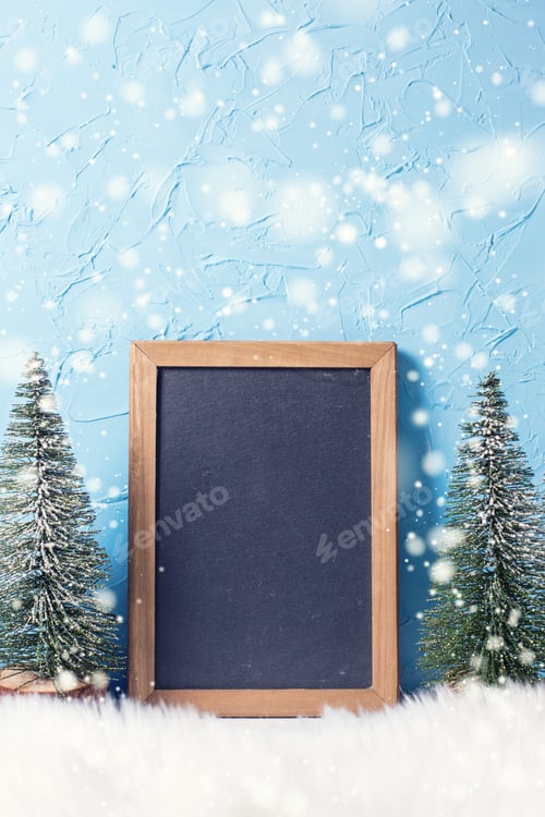 Preview: Empty Blackboard And Decorative Trees Against Blue Textured Background. Minimalistic Winter