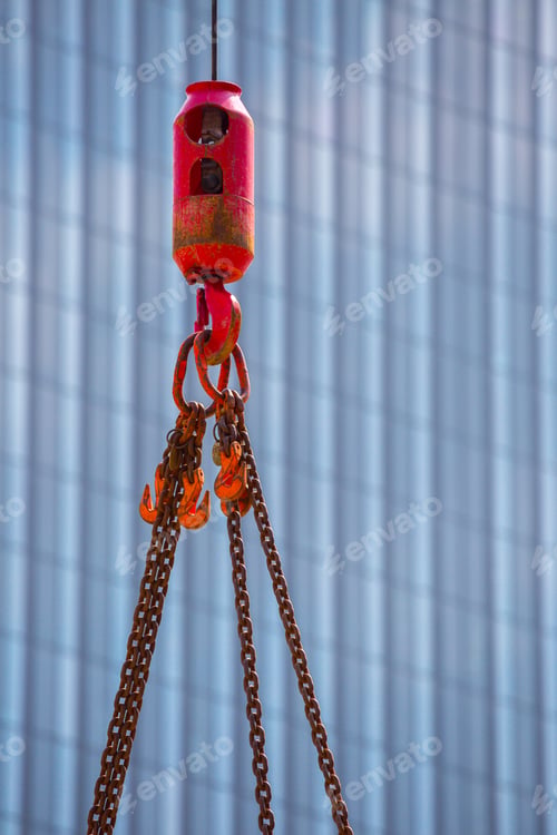 Preview: Crane Hoisting Block With Hook On Steel Chain On Steel Rope. Glass Facade Of A Modern Skyscraper In